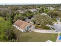 An aerial view shows a home with a large yard and surrounding greenery at 3193 Verbena Ct, Deltona, FL 32725
