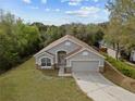 Inviting one-story home with attached garage, pristine lawn and neutral color palette at 3193 Verbena Ct, Deltona, FL 32725