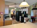 Eat in kitchen with a table, with black appliances and white upper cabinets at 326 Hanging Moss Rd, Davenport, FL 33837