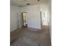 Bright bedroom featuring carpet floors and neutral walls with access to a bathroom and closet at 3557 Valleyview Dr, Kissimmee, FL 34746
