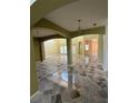 Spacious living room with arches, high ceilings, and marble tile floors, offering an open floor plan at 3557 Valleyview Dr, Kissimmee, FL 34746