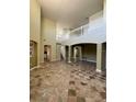 Expansive living room showcasing marble tile floors, high ceilings, and a second-story view at 3557 Valleyview Dr, Kissimmee, FL 34746