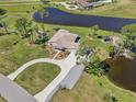 Stunning aerial view of a lakeside property with lush landscaping and a private gazebo at 3607 Hidden River Ln, Tavares, FL 32778