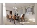 An inviting dining room featuring stylish chairs, modern lighting, and a chic accent wall with a mirrored decor piece at 3607 Hidden River Ln, Tavares, FL 32778