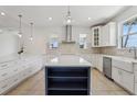 Bright, modern kitchen with white cabinets, an island, stainless steel appliances, and stylish backsplash at 3607 Hidden River Ln, Tavares, FL 32778