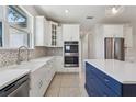 Bright kitchen featuring white cabinets, stainless steel appliances, and an island at 3607 Hidden River Ln, Tavares, FL 32778