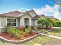 Well-kept home with a lovely yard, mulched flower beds, and attractive landscaping in a suburban neighborhood at 3709 Cedar Hammock Trl, St Cloud, FL 34772