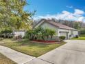 Beautiful single-Gathering home with an attached garage, manicured lawn, and mature palm trees at 3709 Cedar Hammock Trl, St Cloud, FL 34772