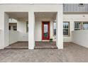 Inviting front porch features brick paving and a striking red door at 7059 Nemours Pkwy, Orlando, FL 32827