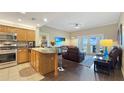 Cozy living area featuring modern furniture, French doors, and a view of the outdoor scenery at 7673 Heritage Crossing Way # 301, Reunion, FL 34747