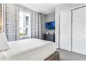 Serene bedroom with a comfortable bed, stylish curtains, and a flat-screen television at 7760 Sandy Ridge Dr # 108, Reunion, FL 34747