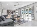 Bright living room featuring a plush sofa, stylish rug, and glass doors leading to an outdoor space at 7760 Sandy Ridge Dr # 108, Reunion, FL 34747