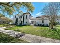 Elegant home featuring a manicured lawn, lush landscaping, and a timeless architectural design at 808 Golfpark Dr, Celebration, FL 34747