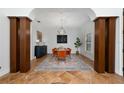 Formal dining room featuring modern lighting, and architectural pillars that frame an elegant design at 8437 Lake Burden Cir, Windermere, FL 34786