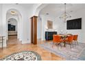 Elegant dining room with modern lighting, tile floors, and arched entryways at 8437 Lake Burden Cir, Windermere, FL 34786