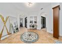 Elegant foyer with tile flooring, arched doorways, and a decorative medallion inlay at 8437 Lake Burden Cir, Windermere, FL 34786