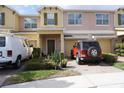 Charming two-story townhouse with attached garage and a well maintained landscaped yard at 1217 Honey Blossom Dr, Orlando, FL 32824