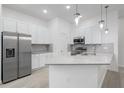 Eat-in kitchen featuring stainless steel refrigerator, granite countertop, and stainless steel appliances at 10287 Ebb Tide Lane, Orlando, FL 32821