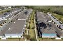 Aerial shot of townhomes with manicured green spaces and walkways creating a community feel at 10394 Spring Arbor Ln, Winter Garden, FL 34787