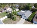 An aerial shot shows a well-maintained home featuring a screened-in pool and lush landscaping at 129 Pine Lake View Dr, Davenport, FL 33837