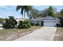Inviting single-story home with a well-maintained lawn and spacious driveway, perfect for Gathering living at 129 Pine Lake View Dr, Davenport, FL 33837