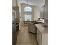 Bright kitchen featuring white cabinets, stainless steel appliances, and a cozy dining area with natural light at 132 Santana Pl, Davenport, FL 33897