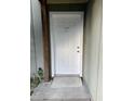 A close-up of the white front door with the number 145 above the doorway and a small ramp for accessibility at 145 Scottsdale Sq # 145, Winter Park, FL 32792