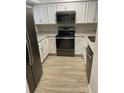 Updated kitchen featuring stainless steel appliances, granite countertops, and modern cabinetry at 145 Scottsdale Sq # 145, Winter Park, FL 32792