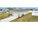 Well-kept house showing the garage and driveway with green grass surrounding the property at 202 Zircon Rd, Kissimmee, FL 34758