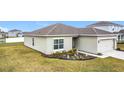 Attractive single-story home with a lush green lawn and manicured landscaping at 202 Zircon Rd, Kissimmee, FL 34758