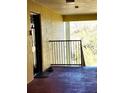 Outdoor balcony with an entrance door and black metal railing, with outside views at 2047 Dixie Belle Dr # 2047 T, Orlando, FL 32812