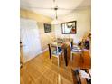 Cozy dining area with wooden table, chairs, and hardwood floors at 2047 Dixie Belle Dr # 2047 T, Orlando, FL 32812