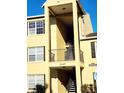 Close-up of building exterior with yellow walls and metal railings at 2047 Dixie Belle Dr # 2047 T, Orlando, FL 32812