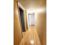 Hallway features wood flooring, neutral walls, white doors, and a closet at 2047 Dixie Belle Dr # 2047 T, Orlando, FL 32812