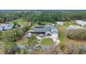 Aerial view of the house and surrounding property, showing the landscaping, pond, and RV parking area at 2086 Blackfoot Trl, St Cloud, FL 34771