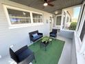 Cozy screened-in porch with comfortable seating and a welcome atmosphere at 2326 S Peninsula Dr, Daytona Beach, FL 32118