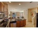 Well-lit kitchen featuring stainless steel appliances, breakfast bar, and easy access to outdoor patio at 2652 Corvette Ln, Kissimmee, FL 34746
