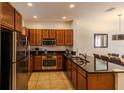 Modern kitchen featuring stainless steel appliances, dark cabinets, and sleek countertops at 2652 Corvette Ln, Kissimmee, FL 34746