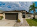 Single-Gathering home boasts a well-maintained lawn, paved walkway and a two-car garage at 2822 Moultrie Creek Dr, Kissimmee, FL 34743