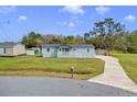 A quaint single story house with a long driveway and well-maintained front lawn on a sunny day at 3139 Morning Light Way, Kissimmee, FL 34744