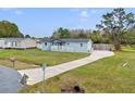 Single story home with long driveway, healthy green lawn and other well maintained homes nearby at 3139 Morning Light Way, Kissimmee, FL 34744
