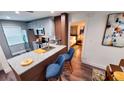 Updated kitchen features stainless appliances and a granite island with seating and bedroom view at 3214 Candle Ridge Dr # 201, Orlando, FL 32822