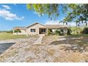 Charming single-story home featuring a landscaped yard and a welcoming walkway under a clear blue sky at 3260 Osceola Rd, St Cloud, FL 34772