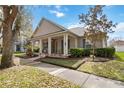 Charming single-story home featuring a welcoming front porch with stately columns and beautiful landscaping at 3317 Schoolhouse Rd, Harmony, FL 34773