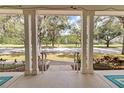 Open porch view with classic columns offering a glimpse of the neighborhood park at 3317 Schoolhouse Rd, Harmony, FL 34773