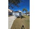 View of the single Gathering home featuring attached garage, driveway and grass lawn at 334 Sonja Cir, Davenport, FL 33897
