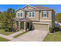 Charming two-story home with a covered porch, attached two-car garage, and a well-manicured lawn at 3384 Cordgrass Pl, Harmony, FL 34773