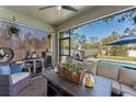 Covered patio with comfortable seating, a ceiling fan, and a view of the pool at 3384 Cordgrass Pl, Harmony, FL 34773