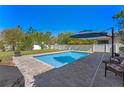 Backyard pool featuring brick patio and landscaping, perfect for outdoor enjoyment at 3384 Cordgrass Pl, Harmony, FL 34773