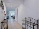 Inviting tiled hallway with neutral walls and decor leading to an open-concept living area at 3818 Carrick Bend Dr, Kissimmee, FL 34746